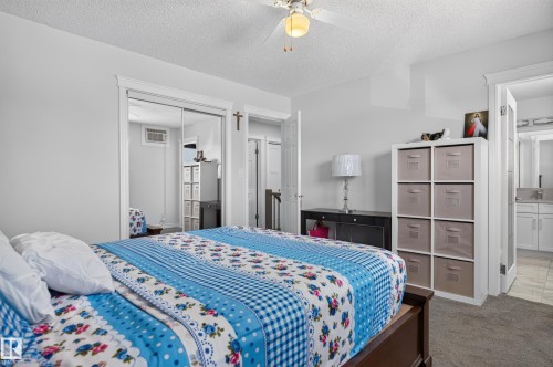 Mirrored closet doors, ceiling fan with integrated lighting, paneled doors, and carpet flooring - 8632 184 Street Nw, Edmonton, AB - Indoor Photo Showing Bedroom