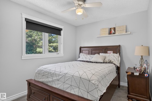 Recessed window with white trim, soft gray walls, and textured ceiling - 8632 184 Street Nw, Edmonton, AB - Indoor Photo Showing Bedroom