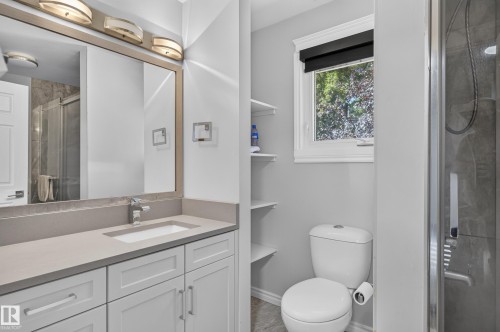 Neutral-toned vanity with an integrated sink and chrome faucet - 8632 184 Street Nw, Edmonton, AB - Indoor Photo Showing Bathroom