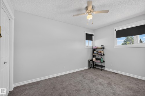 Neutral gray carpeting, white trim, and a ceiling fan with integrated lighting - 8632 184 Street Nw, Edmonton, AB - Indoor