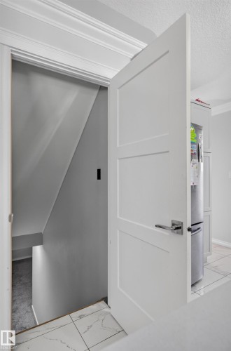 White paneled door with a polished chrome lever handle - 8632 184 Street Nw, Edmonton, AB - Indoor Photo Showing Other Room