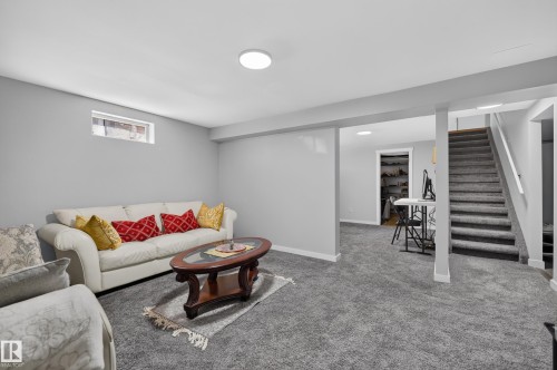 Carpeted lower-level living area with gray walls, recessed lighting, and a window - 8632 184 Street Nw, Edmonton, AB - Indoor
