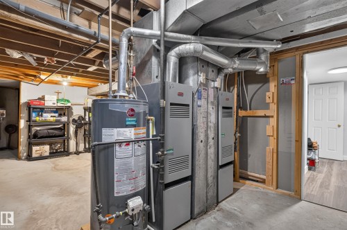 Utility space featuring a water heater and multiple furnace units - 8632 184 Street Nw, Edmonton, AB - Indoor Photo Showing Basement