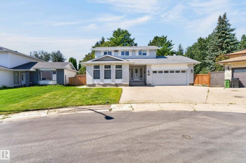 Two-story residence featuring light-colored brick veneer, an attached two-car garage, and a concrete driveway - 8632 184 Street Nw, Edmonton, AB - Outdoor With Facade