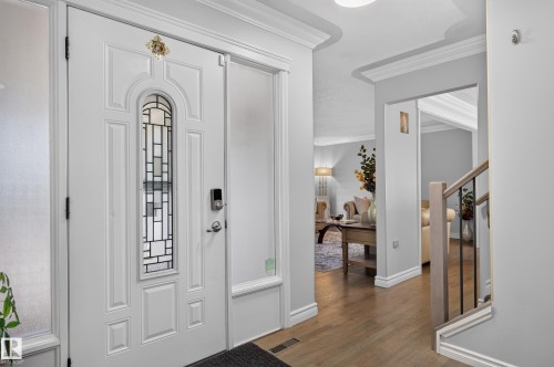 Entryway featuring a white paneled door with decorative glass insert and sidelights - 8632 184 Street Nw, Edmonton, AB - Indoor Photo Showing Other Room