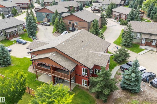 Red-toned exterior with a multi-level deck and covered patio - 203 Graybriar Green, Stony Plain, AB - Outdoor With Deck Patio Veranda