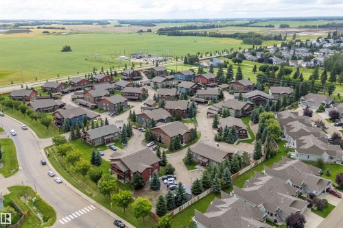 Residential community featuring detached and attached properties with varied rooflines - 203 Graybriar Green, Stony Plain, AB - Outdoor With View