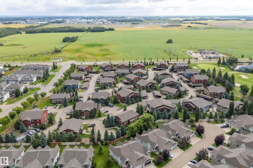 Residential development with varied architectural styles, mature trees, and paved streets - 203 Graybriar Green, Stony Plain, AB - Outdoor With View