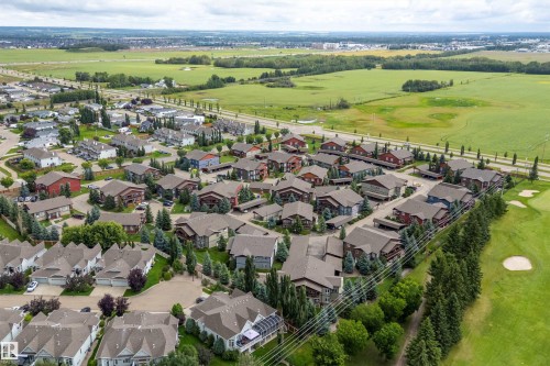 Residential area with a variety of housing styles, extensive green spaces, and adjacent golf course - 203 Graybriar Green, Stony Plain, AB - Outdoor With View