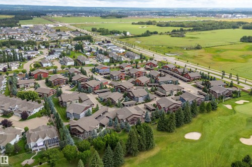Residential community with varied architectural styles, bordered by extensive green spaces and a golf course - 203 Graybriar Green, Stony Plain, AB - Outdoor With View