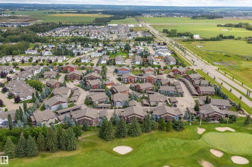 Residential community featuring a golf course, mature trees, and paved roadways - 203 Graybriar Green, Stony Plain, AB - Outdoor With View