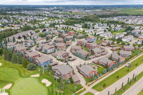Residential community with diverse housing styles, adjacent to a manicured golf course - 203 Graybriar Green, Stony Plain, AB - Outdoor With View