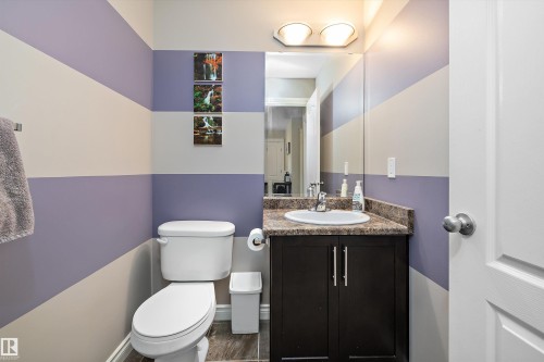 Pedestal sink with a faucet, vanity with cabinet storage, and a mirror - 3922 Agar Court Sw, Edmonton, AB - Indoor Photo Showing Bathroom