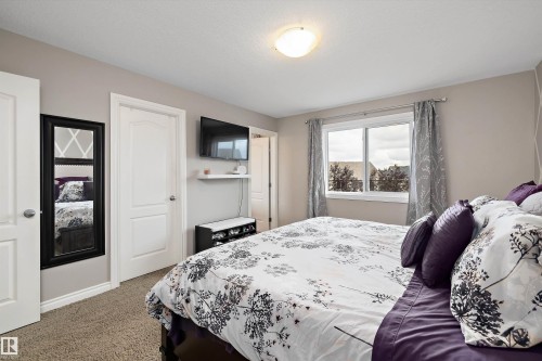 Neutral-toned walls complement the window with a white frame - 3922 Agar Court Sw, Edmonton, AB - Indoor Photo Showing Bedroom