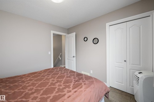 Neutral-toned walls complement the carpeted flooring - 3922 Agar Court Sw, Edmonton, AB - Indoor Photo Showing Bedroom