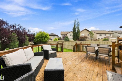 Expansive wood deck with a perimeter railing, integrated lighting, and a manicured lawn - 3922 Agar Court Sw, Edmonton, AB - Outdoor With Deck Patio Veranda With Exterior