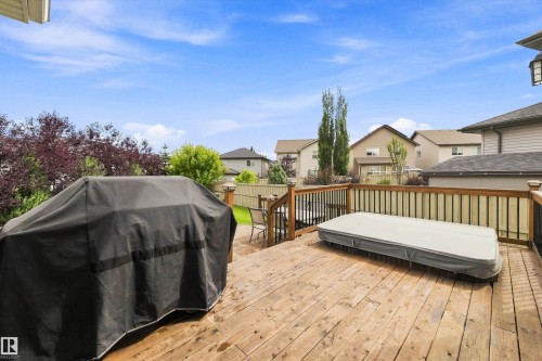 Expansive wood deck with a dark wood railing and black balusters - 3922 Agar Court Sw, Edmonton, AB - Outdoor With Deck Patio Veranda With Exterior