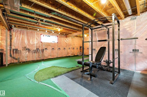 Unfinished basement featuring exposed wood joists and subflooring, insulated walls, and a recessed window - 3922 Agar Court Sw, Edmonton, AB - Indoor Photo Showing Basement