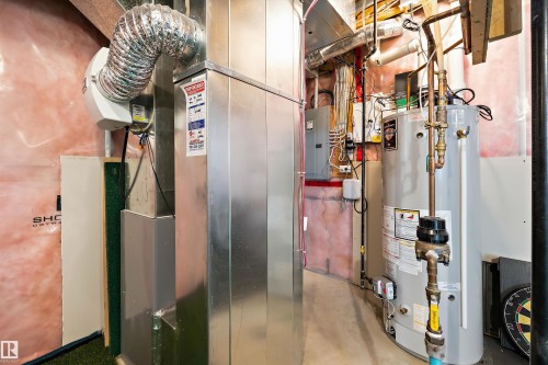 Water heater and furnace system with exposed ductwork - 3922 Agar Court Sw, Edmonton, AB - Indoor Photo Showing Basement