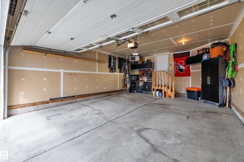 Concrete flooring, overhead lighting, interior access door, wood-finish staircase - 3922 Agar Court Sw, Edmonton, AB - Indoor Photo Showing Garage