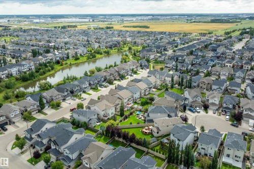 Established neighborhood featuring a central pond, abundant green spaces, and a variety of architectural styles - 3922 Agar Court Sw, Edmonton, AB - Outdoor With View