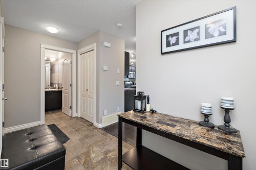 Tile flooring, neutral wall tones, white trim, and a built-in vanity with a vessel sink - 3922 Agar Court Sw, Edmonton, AB - Indoor Photo Showing Other Room