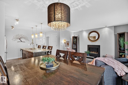 6642 Cardinal Road Sw, Edmonton, AB - Indoor Photo Showing Dining Room With Fireplace
