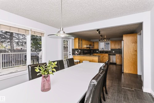 Spacious dining area with direct outdoor access to a deck, and an overhead pendant light - 6016 177 Street Nw, Edmonton, AB - Indoor Photo Showing Dining Room