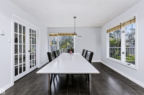 Spacious room featuring dark wood-finish flooring, white trim, and a white ceiling - 6016 177 Street Nw, Edmonton, AB - Indoor Photo Showing Dining Room