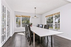 White interior walls with dark wood-finish tile flooring - 