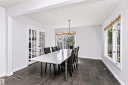 French doors with glass panes, transom windows, pendant lighting, and tile flooring - 