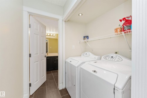 Integrated laundry area with tile flooring and wire shelving - 6016 177 Street Nw, Edmonton, AB - Indoor Photo Showing Laundry Room