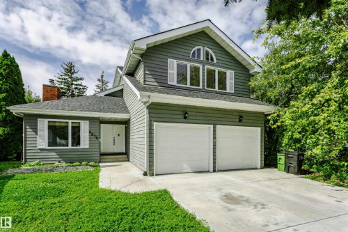 Gable roofline with dormer windows, two-car garage, and brick chimney detail - 6016 177 Street Nw, Edmonton, AB - Outdoor