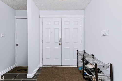 Dual panel entry door with panel detailing - 6016 177 Street Nw, Edmonton, AB - Indoor Photo Showing Other Room