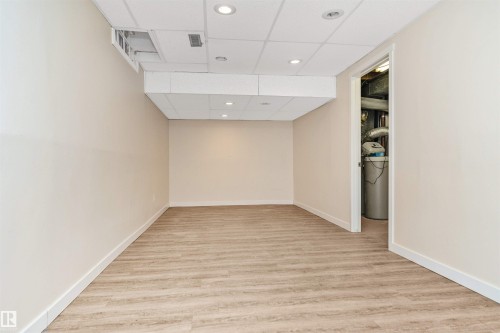 Recessed lighting illuminating wood-finish flooring - 6016 177 Street Nw, Edmonton, AB - Indoor Photo Showing Other Room