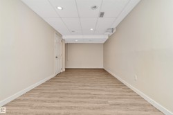 Neutral wall tones, wood-finish flooring, recessed lighting, and a drop ceiling - 