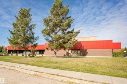 Brown brick exterior with red metal siding accents - 