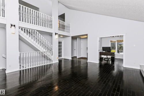 Vaulted ceilings with dark wood-finish flooring - 6016 177 Street Nw, Edmonton, AB - Indoor Photo Showing Other Room