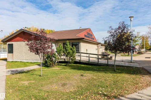 Building exterior with stucco finish and red siding - 6016 177 Street Nw, Edmonton, AB - Outdoor