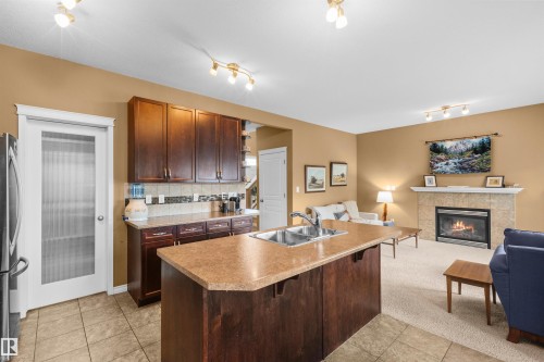 407 Brintnell Boulevard Nw, Edmonton, AB - Indoor Photo Showing Kitchen With Fireplace With Double Sink