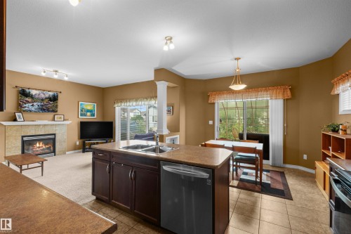 407 Brintnell Boulevard Nw, Edmonton, AB - Indoor Photo Showing Kitchen With Fireplace With Double Sink