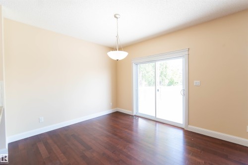 Wood-finish flooring with white trim and a neutral wall color - 1419 Chahley Place Nw, Edmonton, AB - Indoor Photo Showing Other Room