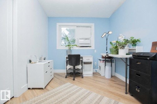Room featuring light blue and white painted walls, wood-finish flooring, and white trim - 11131 52 Street Nw, Edmonton, AB - Indoor