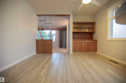 Light-toned wood-finish flooring throughout - 11131 52 Street Nw, Edmonton, AB - Indoor Photo Showing Other Room