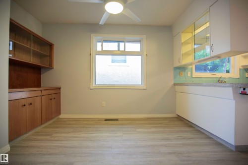 Neutral wall paint with light wood-finish flooring - 11131 52 Street Nw, Edmonton, AB - Indoor Photo Showing Other Room