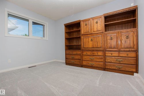 Built-in wood cabinetry and shelving provide extensive storage - 11131 52 Street Nw, Edmonton, AB - Indoor