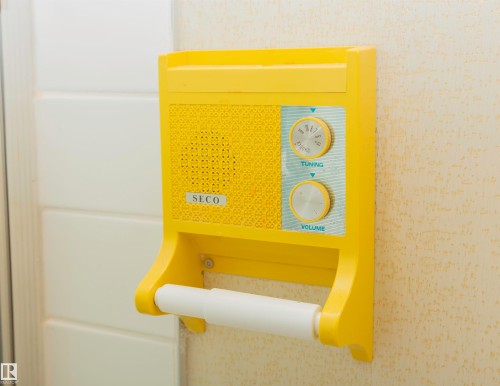 Original SECO Built-In Radio with tuning and volume controls, integrated with a toilet paper holder - 11131 52 Street Nw, Edmonton, AB - Indoor