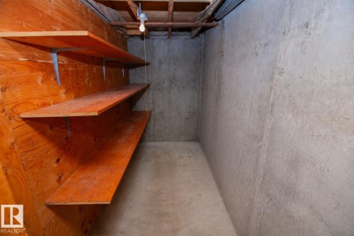Storage area featuring concrete flooring and walls - 11131 52 Street Nw, Edmonton, AB - Indoor