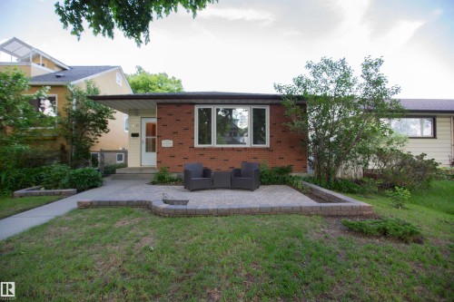 Brick-front exterior with a flat roofline and a paved patio area - 11131 52 Street Nw, Edmonton, AB - Outdoor