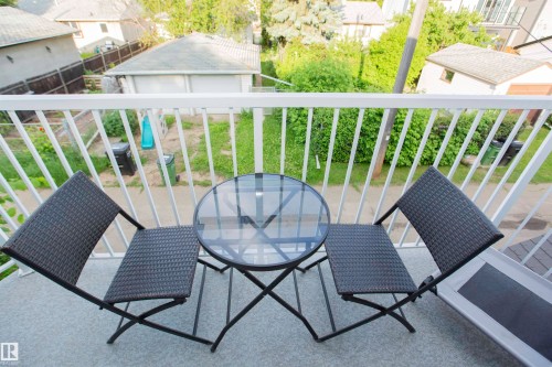 Balcony with white metal railing and a grey textured floor - 11131 52 Street Nw, Edmonton, AB - Outdoor With Exterior